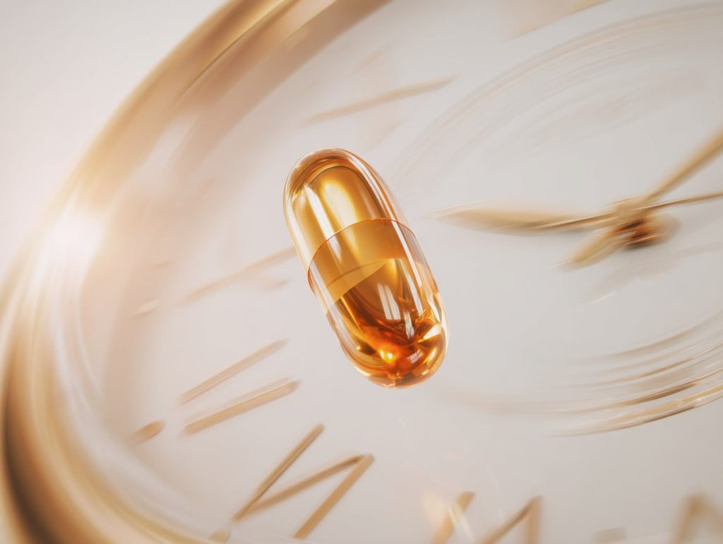 Sildenafil vs Tadalafil: Which Option Suits Your Lifestyle? 3 Golden capsule floats over blurred clock, symbolising long-lasting tadalafil effect and flexible timing in ED treatment